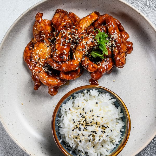 Lucky Chopsticks' General Tso's chicken with sesame seeds and a side of white rice.